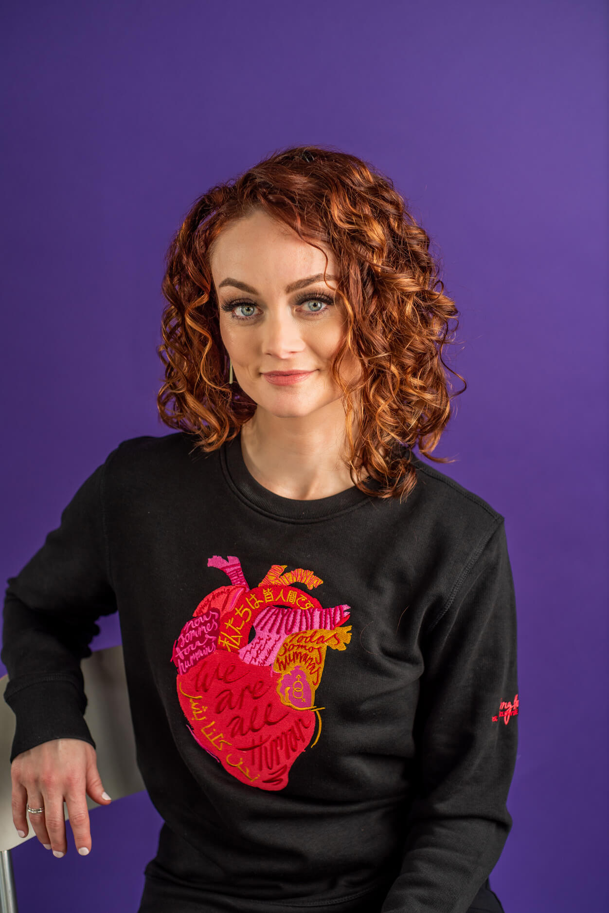 Kristin Flanary wearing a black sweater with an anatomical heart.
