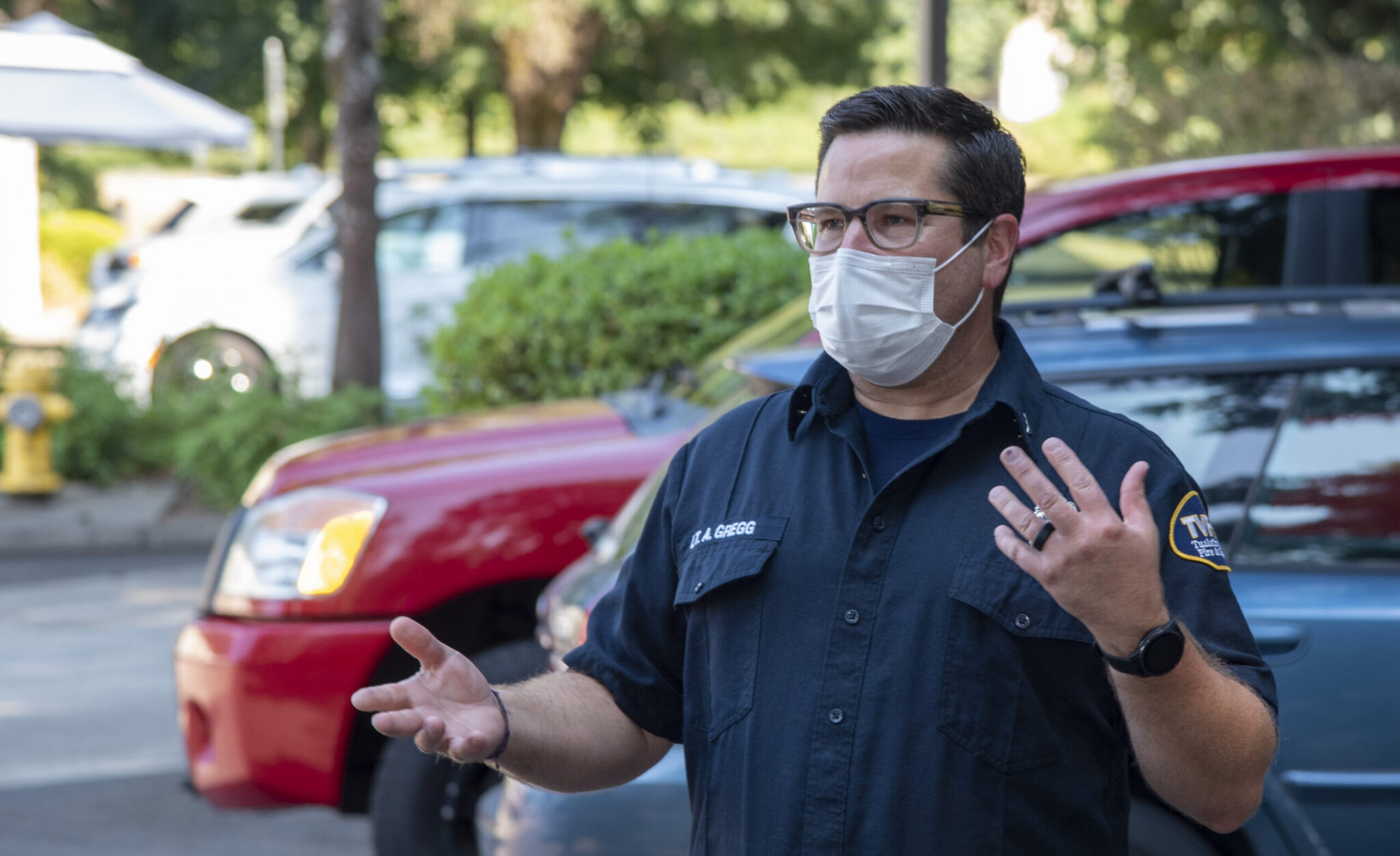 A photo of a man standing outside wearing a face mask