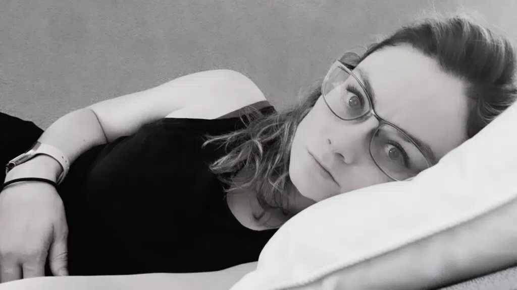 A photo I took in the aftermath of Will's SCA. You can see how I had dissociated – the light was gone from my eyes. It's black and white, and I'm laying on my side as I look directly at the camera.