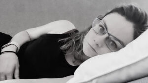 A photo I took in the aftermath of Will's SCA. You can see how I had dissociated – the light was gone from my eyes. It's black and white, and I'm laying on my side as I look directly at the camera.